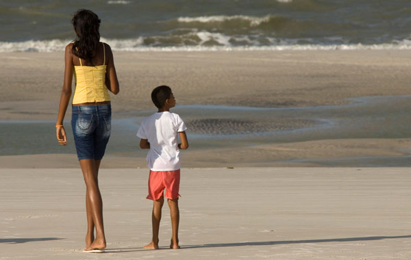 Fourteen-year-old Elisany Silva, who measures 2.06 meters (6'9") tall, walks with a friend on Ajuruteua beach in Braganca in the Brazilian Amazon state of Para. (REUTERS)