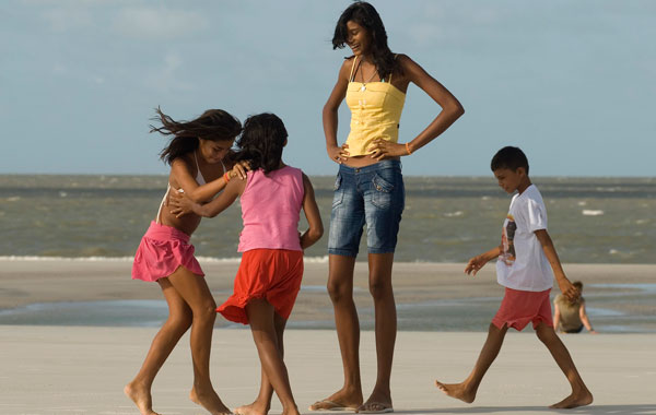 Fourteen-year-old Elisany Silva, who measures 2.06 meters (6'9") tall, plays with her sisters and a friend on Ajuruteua beach in Braganca in the Brazilian Amazon state of Para. (REUTERS)