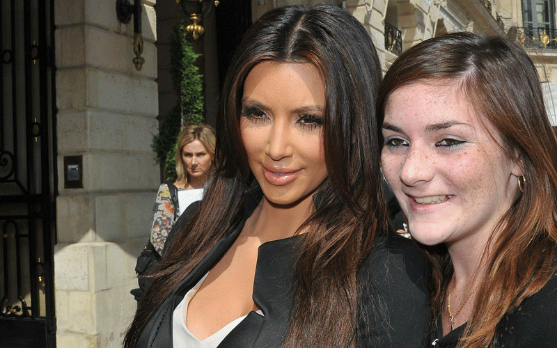 Kim Kardashian poses with fan outside the Ritz hotel. (GETTY IMAGES)