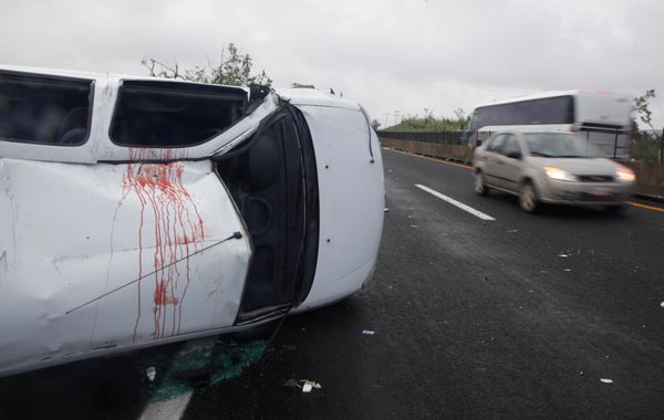 A turned over car with a blood stain on its roof is seen at a highway after the passage of Hurricane Karl on the outskirts of Veracruz, Mexico. (AP)