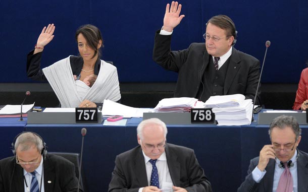 European Parliament member Licia Ronzulli (back L) has her baby in a wraparound baby carrier as she and other MPs of the Group of the European People's Party participate in a voting during the plenary session of the European Parliament in Strasbourg, France. (EPA)