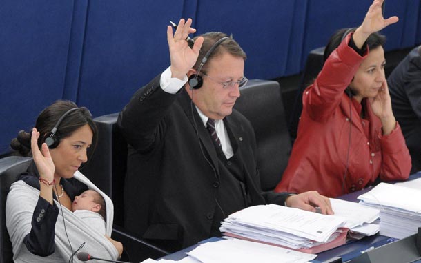 European Parliament member Licia Ronzulli (back L) has her baby in a wraparound baby carrier as she and other MPs of the Group of the European People's Party participate in a voting during the plenary session of the European Parliament in Strasbourg, France. (EPA)