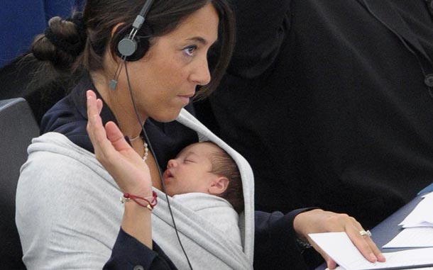 European Parliament member Licia Ronzulli (back L) has her baby in a wraparound baby carrier as she and other MPs of the Group of the European People's Party participate in a voting during the plenary session of the European Parliament in Strasbourg, France. (EPA)