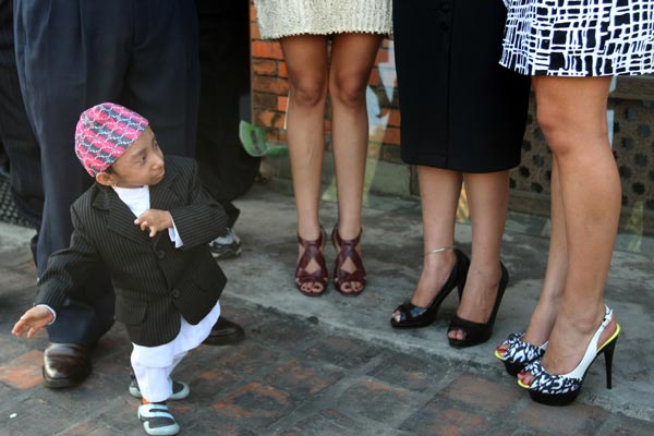 Nepalese teenager Khagendra Thapa Magar poses for a picture with Miss Nepal Sadichha Shrestha (C) and first runner-up Sahana Bajracharya (R) and second runner-up Samyukta Timilsina (L). (AFP)