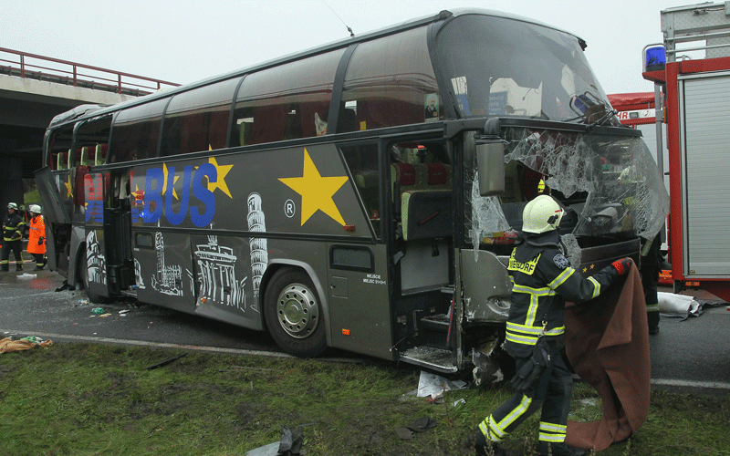 A fireman walks next to the smashed front windshield of a tour bus that crashed into a concrete bridge support on the A10 highway near Berlin, Germany. According to police at least 11 people were killed and seven seriously injured. (GETTY IMAGES)