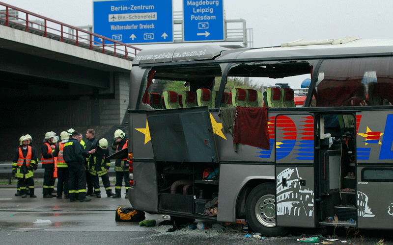 Firemen and rescue workers stand around a tour bus that crashed into a concrete bridge support on the A10 highway near Berlin, Germany. According to police on site at least 11 people were killed and 7 seriously injured. (GETTY IMAGES)
