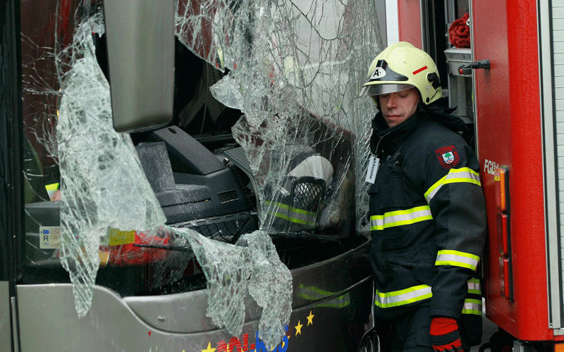 A fireman stands next to the smashed, front windshield of a tour bus that crashed into a concrete bridge support on the A10 highway near Berlin, Germany. According to police on site at least 11 people were killed and 7 seriously injured. (GETTY IMAGES)