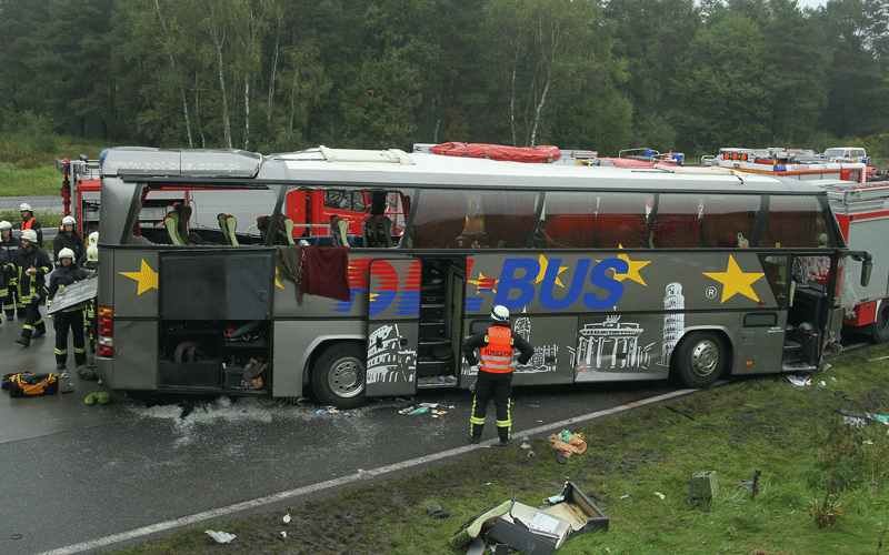 Firemen and rescue workers stand around a tour bus that crashed into a concrete bridge support on the A10 highway near Berlin, Germany. According to police on site at least 11 people were killed and 7 seriously injured. (GETTY IMAGES)