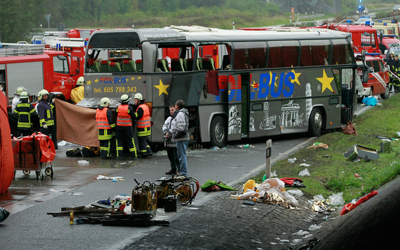 Firemen and rescue workers stand around a tour bus that crashed into a concrete bridge support on the A10 highway near Berlin, Germany. According to police at least 11 people were killed and seven seriously injured. (GETTY IMAGES)