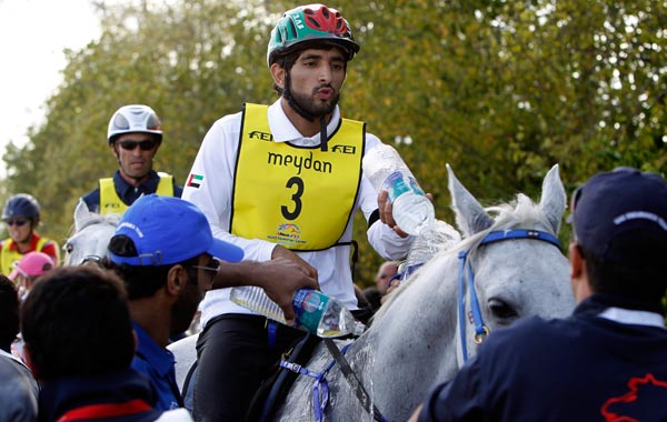 Sheikh Hamdan bin Mohammed al Makhtoum of the United Arab Emirates riding SAS Alexis pours water on his horse during the World Endurance Championship at the World Equestrian Games in Lexington, Kentuck. (REUTERS)