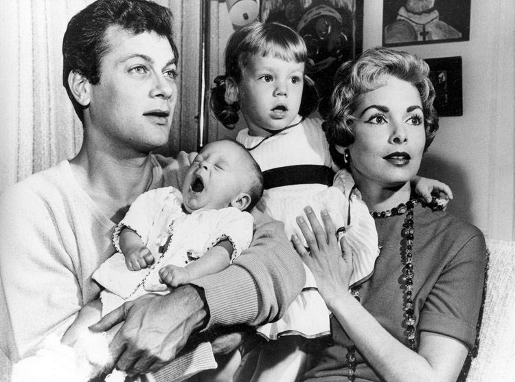 Tony Curtis and Janet Leigh are shown with their daughters Kelly, and the newborn Jamie Lee in Hollywood in this 1959 file photo (AP)
