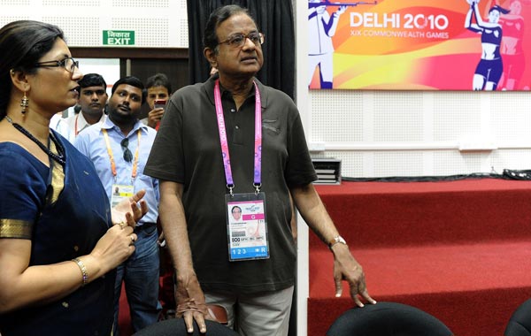 Indian Home Minister P. Chidambaram (R) talks to a official while visiting The Commonwealth Games Main Press Centre (MPC)  in New Delhi. (AFP)