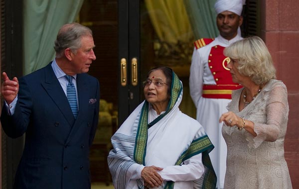 Prince Charles, Prince of Wales (L) and Camilla, Duchess of Cornwall (R) stand with Indian President Pratibha Patil on the first day of their four day visit to India in the garden of the Presidential palace. (GETTY)