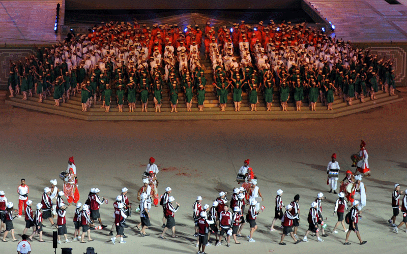 Athletes from Canada (foreground) walk past as dancers perform during the XIX Commonwealth Games opening ceremony at the Jawaharlal Nehru Stadium in New Delhi. (AFP)