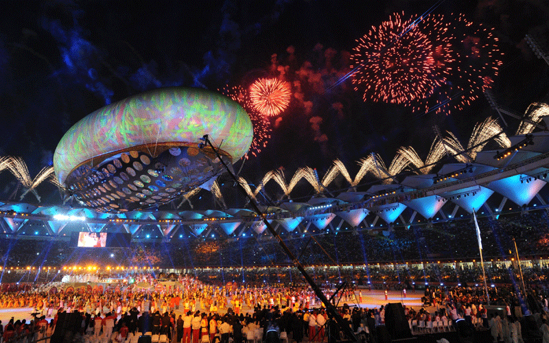 Fireworks light up the sky as performers dance underneath the aerostat during the XIX Commonwealth Games opening ceremony at the Jawaharlal Nehru Stadium in New Delhi. (AFP)