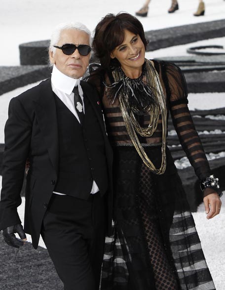 German fashion designer Karl Lagerfeld, left, and French former model and now designer Ines de la Fressange take the catwalk, at the Grand Palais museum, at the end of Lagerfeld's spring-summer 2011 ready to wear collection for Chanel, in Paris (AP)