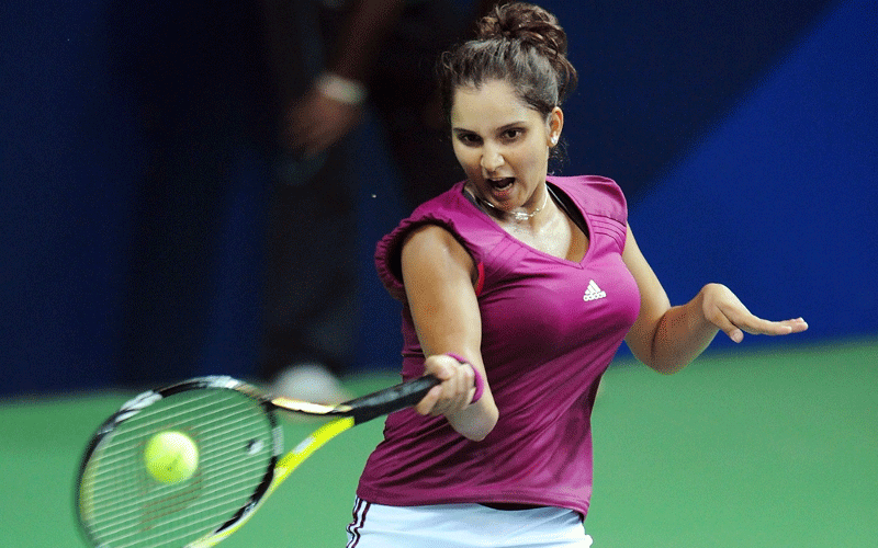 Sania Mirza of India returns a ball to Anastasia Rodionova of Australia in the Women's Single Final match in the XIX Commonwealth Games at the RK Khanna Stadium in New Delhi. (AFP)