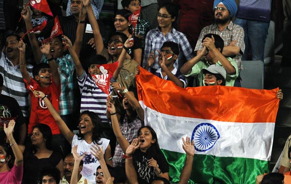 Indian spectators cheer their team on during their field hockey match against Pakistan for the XIX Commonwealth Games at The Major Dhyan Chand National Stadium in New Delhi. (AFP)