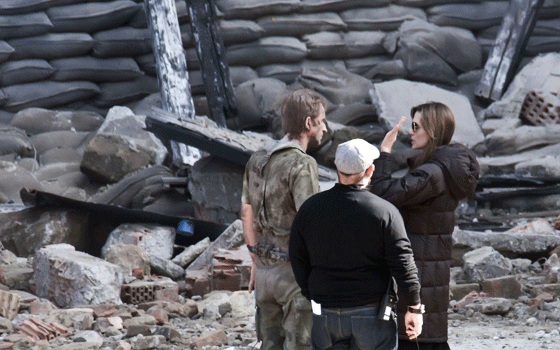 Serbian actor Rade Serbedzija listens to the instructions of US actress Angelina Jolie, right, during the shooting of Jolie’s directorial debut, a film called "Untitled Bosnian War Love Story" about a young Serb and a Muslim woman who fell in love several evenings before the beginning of the Bosnian war in Budapest, Hungary. (AP)