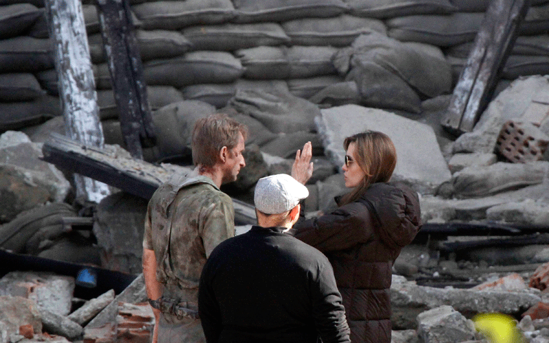 Angelina Jolie (R) talks to cast members during the filming of her first movie "Untitled Bosnian War Love Story" in central Budapest. (REUTERS)