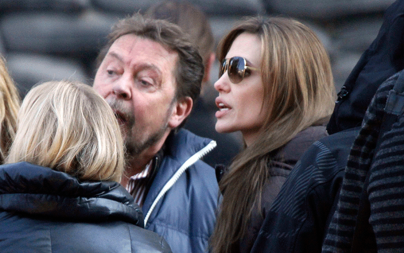Angelina Jolie (R) talks to cast members during the filming of her first movie "Untitled Bosnian War Love Story" in central Budapest. Jolie will direct her first feature film about a Serbian man and Bosnian woman who meet on the eve of the 1992-95 Bosnian war. (REUTERS)