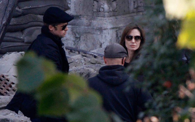 Brad Pitt (L) and Angelina Jolie are pictured in the set during the filming of her first movie "Untitled Bosnian War Love Story" in central Budapest. Jolie will direct her first feature film about a Serbian man and Bosnian woman who meet on the eve of the 1992-95 Bosnian war. (REUTERS)