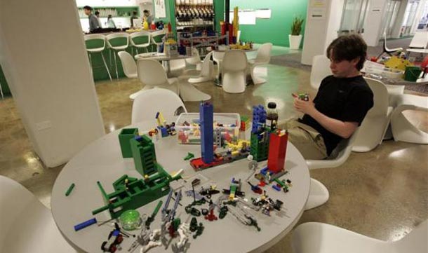 An employee plays with lego at the New York City offices of Google. (REUTERS)