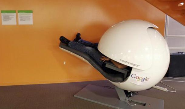 An employee takes a nap in a nap pod which blocks out light and sound at the Google headquarters in Mountain View. (REUTERS)