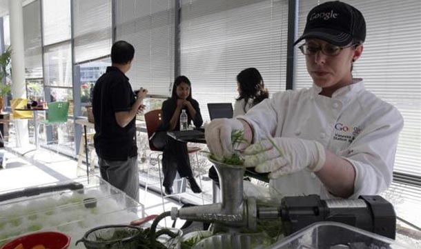 A food service employee juices a shot of wheat grass at Google headquarters in Mountain View. (REUTERS)