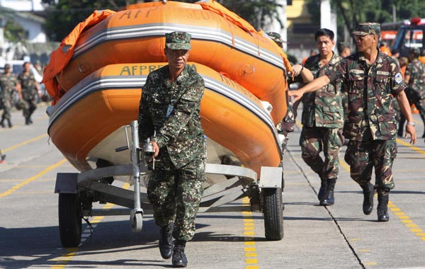 Armed Forces of the Philippines troops prepare rubber boats to be used for disaster response and rescue missions in areas that could be affected by typhoon Megi (local name Juan), during an inspection assembly at military headquarters in Quezon City, east of Manila, Philippines. (EPA)