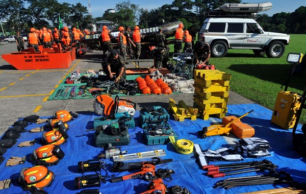 Military rescuers and volunteers prepare life-saving equipments at Camp Aguinaldo in Manila. (AFP)