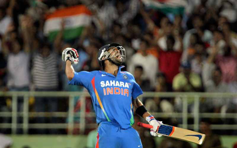 Virat Kohli reacts after scoring a century during the second one day international against Australia in Visakhapatnam, India. (AP)