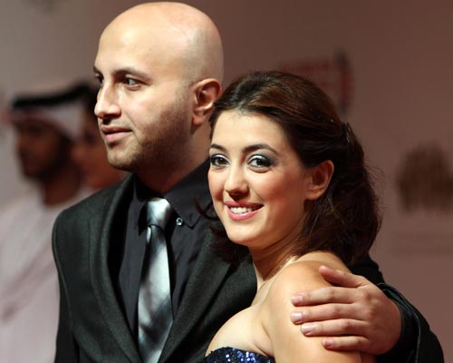 Syrian actress Kinda Alloush (R) arrives to attend the award ceremony of the Abu Dhabi Film Festival in Abu Dhabi, United Arab Emirates. (EPA)