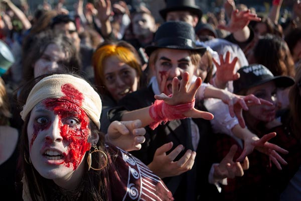 People dressed as zombies moan and shout for brains on Parliament Hill in Ottawa, Ontario. (AP)