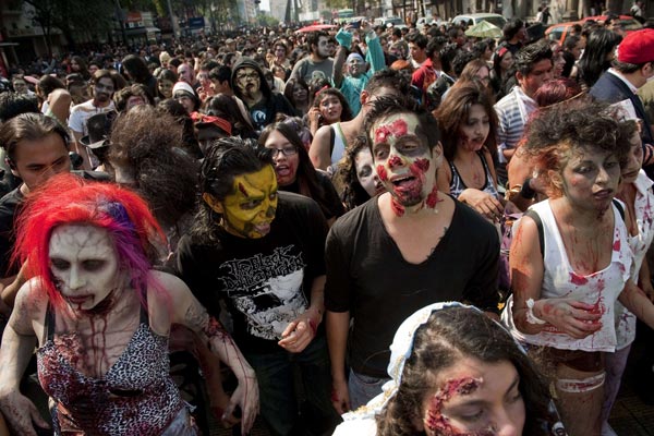 People dressed up as zombies participate in a "Zombie Walk" along Reforma Avenue in Mexico City. (AFP)