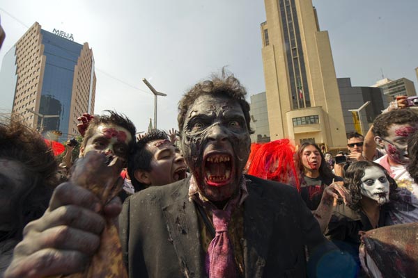 People dressed up as zombies participate in a "Zombie Walk" along Reforma Avenue in Mexico City. (AFP)