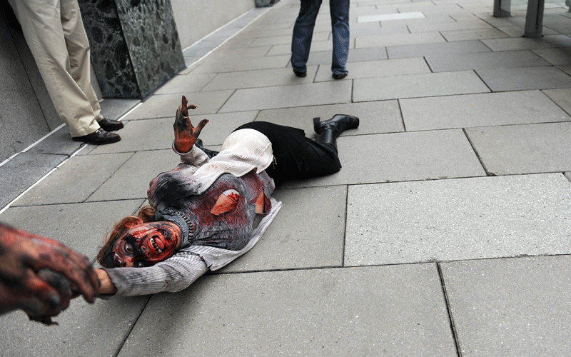 A an actress portraying a zombie to promote the new TV series "The Walking Dead" on the AMC channel is dragged on a city side walk on October 26, 2010 outside the Metro Center subway entrance in Washington, DC. (AFP)