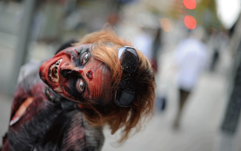 An actress portraying a zombie poses for a picture to promote the new TV series "The Walking Dead" on the AMC channel on October 26, 2010 outside the Metro Center subway entrance in Washington, DC. (AFP)