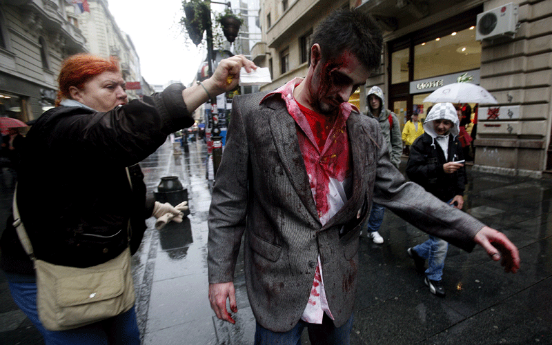Actors dressed as a zombies walk on a street in Belgrade on October 26, 2010, as part of a promotional campaign for an upcoming US TV series called "The Walking Dead". The event is taking place over 24 hours in 26 cities around the world ahead of the show's US premiere on Sunday. (AFP)