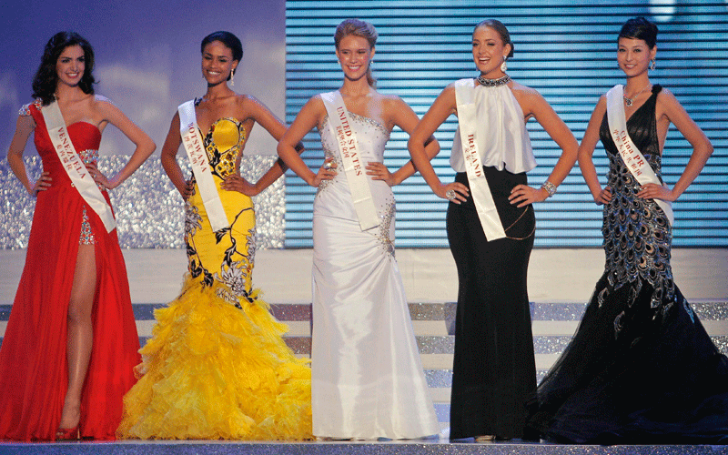 Miss U.S.A. Alexandria Mills, center, Miss Venezuela Adriana Vasini, left, Miss Botswana Emma Wareus, second left, Miss Ireland Emma Waldron, second right, and Miss China Tang Xiao, right, stand together as the five finalists during the 2010 Miss World pageant contest at the Beauty Crown Cultural Center in Sanya, in southern China's island province Hainan. (AP)