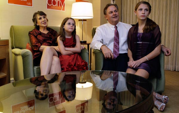 Republican senatorial candidate Carly Fiorina (L) watches election results in her hotel room with husband Frank Fiorina (2nd R) and granddaughters Kara Tribby (2nd L) and Morgan Tribby (R) before attending the California Republican Party election night party in Irvine, California. (REUTERS)