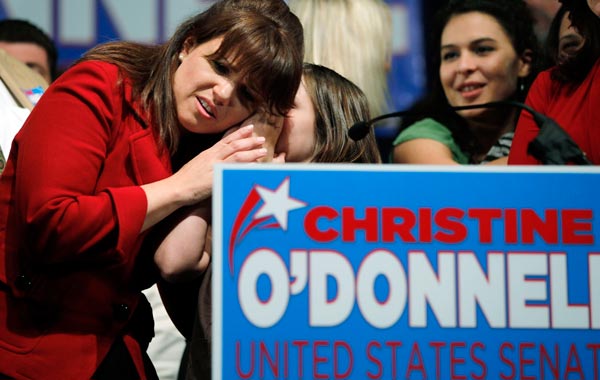 A young girl whispers in the ear of Republican U.S. Senatorial candidate from Delaware Christine O'Donnell after she delivered her concession speech to Democrat Chris Coons during an election night rally in Dover, Delawar. (AFP)