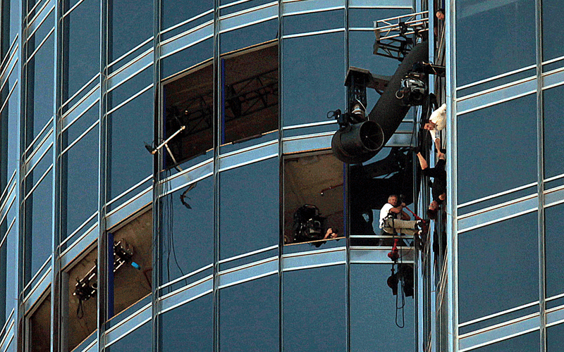 US actor Tom Cruise and his crew are hanging by ropes from the top of the world’s tallest building, the Burj Khalifa, while filming a stunt for Mission: Impossible Ghost Protocol in Dubai, November 3, 2010. (PATRICK CASTILLO)
