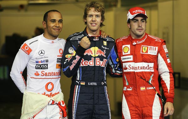 Pole sitter Sebastian Vettel (C) of Germany and Red Bull Racing celebrates with second placed Lewis Hamilton (L) of Great Britain and McLaren Mercedes and third placed Fernando Alonso (R) of Spain and Ferrari following qualifying for the Abu Dhabi Formula One Grand Prix at the Yas Marina Circuit. (GETTY)