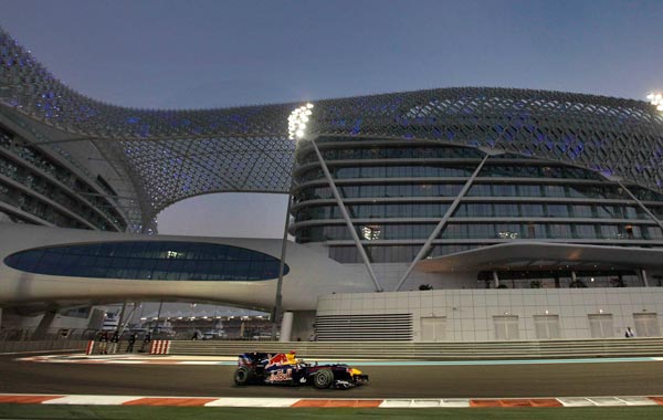 Red Bull driver Sebastian Vettel of Germany passes the Yas Marina hotel during the qualifying session at the Yas Marina racetrack in Abu Dhabi, United Arab Emirates. (AP)