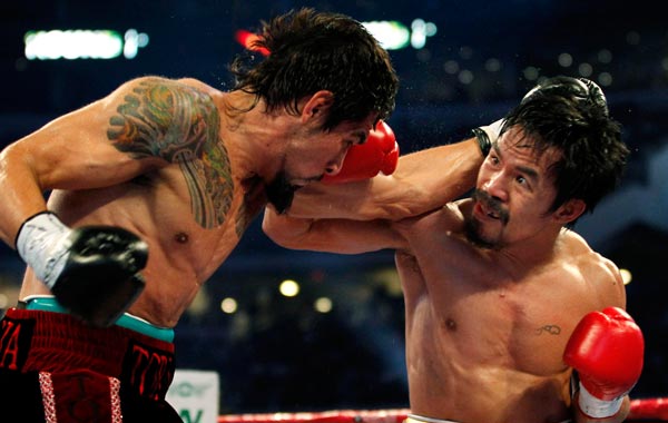 Manny Pacquiao (R) of the Phillippines fights Antonio Margarito of Mexico during the second round of their 12-round WBC World Super Welterweight title boxing fight in Arlington, Texas. (REUTERS)