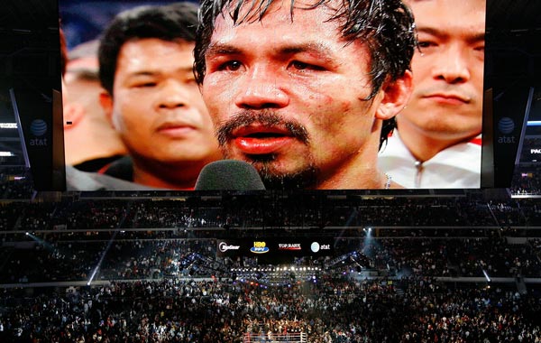 THe likeness of Manny Pacquiao (white trunks) of the Philippines is seen on the giant screen as he is interviewed after he won against Antonio Margarito (black trunks) of Mexico during their WBC World Super Welterweight Title bout at Cowboys Stadium. (AFP)