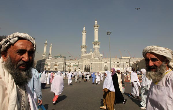 Muslim pilgrims walk outside the Grand Mosque during the annual haj pilgrimage in Mecca. (REUTERS)