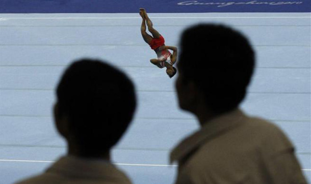 India's Ashish Kumar performs a routine in the men's floor final during artistic gymnastics at the 16th Asian Games in Guangzhou, Guangdong province. Kumar received the bronze medal. (REUTERS)