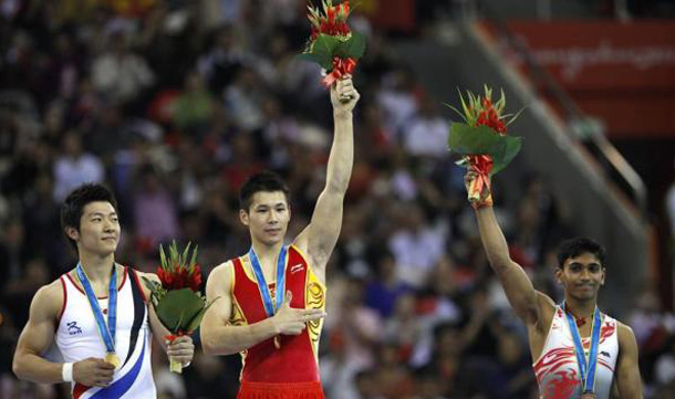 China's Zhang Chenglong (C) and South Korea's Kim Soo-myun (L) stand with their gold medals after the men's floor final during artistic gymnastics at the 16th Asian Games in Guangzhou, Guangdong province. India's Ashish Kumar stands with his bronze medal. (REUTERS)
